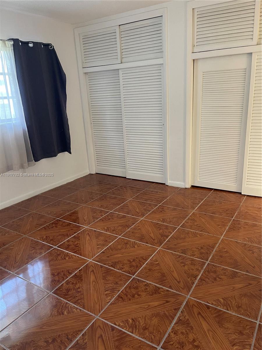 7328 Southwest 82nd Street, Unit B213 Miami, FL 33143 - Photo 18 of 22 a view of a room with wooden floor and door