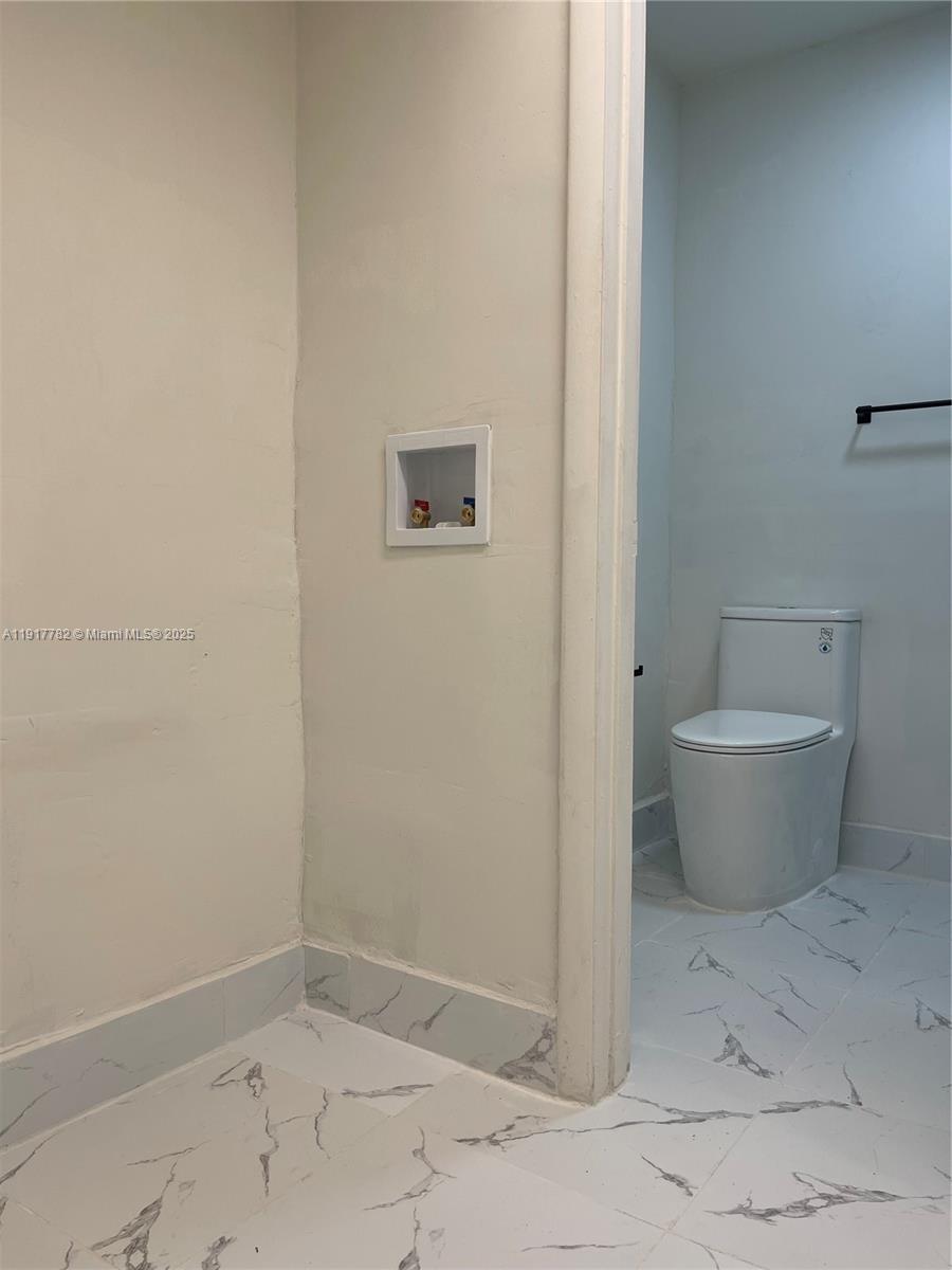 7328 Southwest 82nd Street, Unit B213 Miami, FL 33143 - Photo 5 of 22 a view of a room with racks on the wall