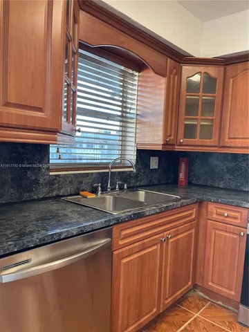 a kitchen with stainless steel appliances granite countertop a sink and cabinets