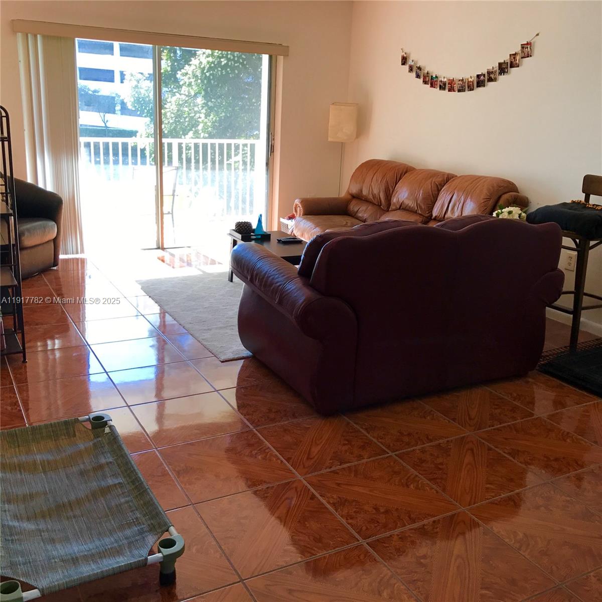 7328 Southwest 82nd Street, Unit B213 Miami, FL 33143 - Photo 9 of 22 a living room with furniture and a floor to ceiling window