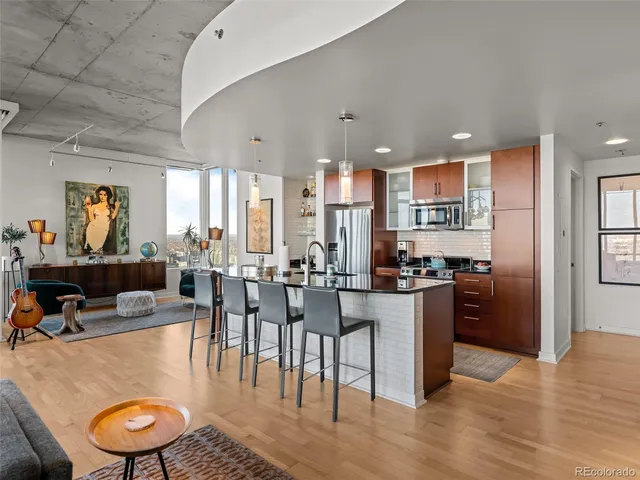 a kitchen with stainless steel appliances granite countertop a refrigerator and a stove top oven