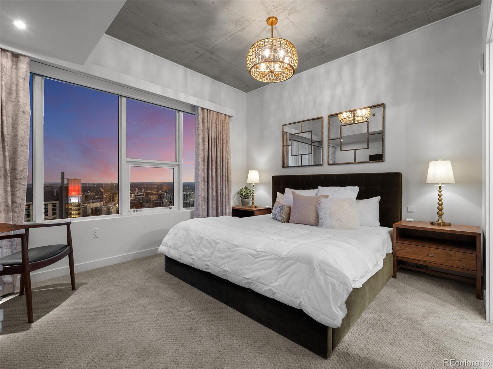 891 14th Street, Unit 4109 Denver, CO 80202 - Photo 18 of 50 a spacious bedroom with a bed and a large window