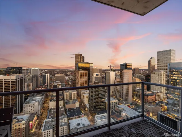 a view of a balcony with a table and chairs and a fire pit