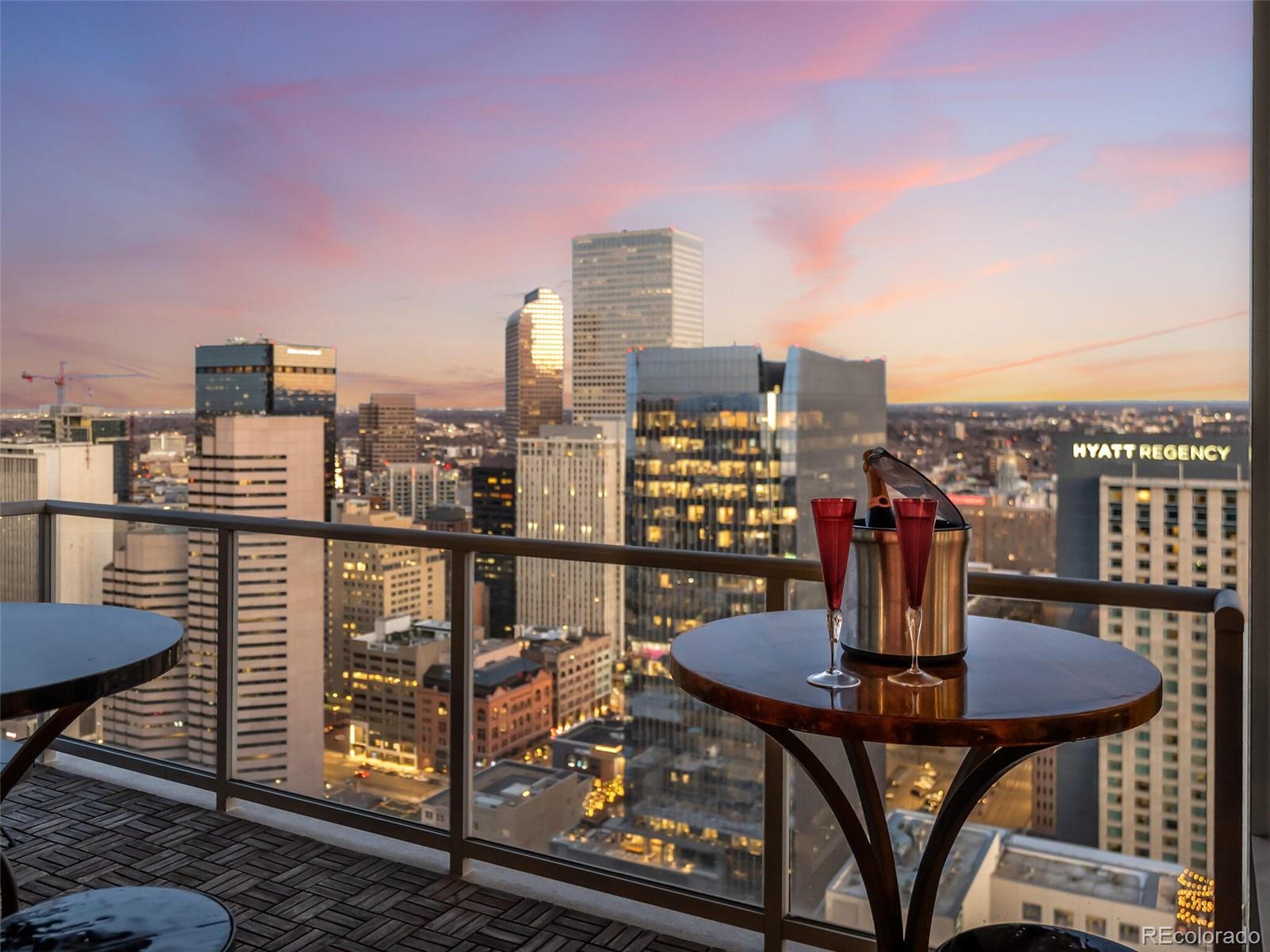 891 14th Street, Unit 4109 Denver, CO 80202 - Photo 25 of 50 a view of a balcony with a table and chairs and a fire pit