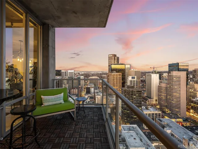 a view of a chairs and table in a balcony