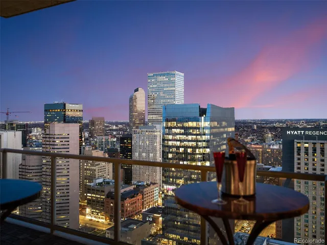 a view of a balcony with table and chairs