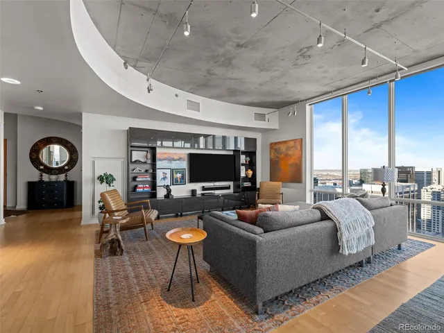a living room with furniture wooden floor and a table