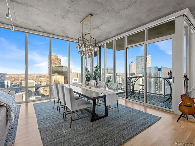 a dining room with stainless steel appliances kitchen island granite countertop a dining table chairs and view living room