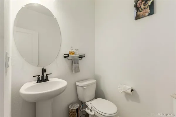 a bathroom with a sink mirror and toilet