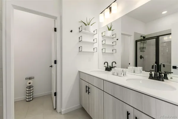 a bathroom with a double vanity sink mirror and double