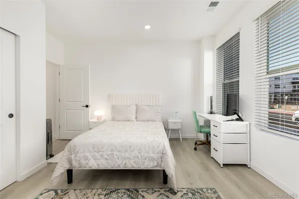 a bedroom with a bed and a desk