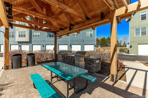 a building outdoor space with patio furniture and potted plants