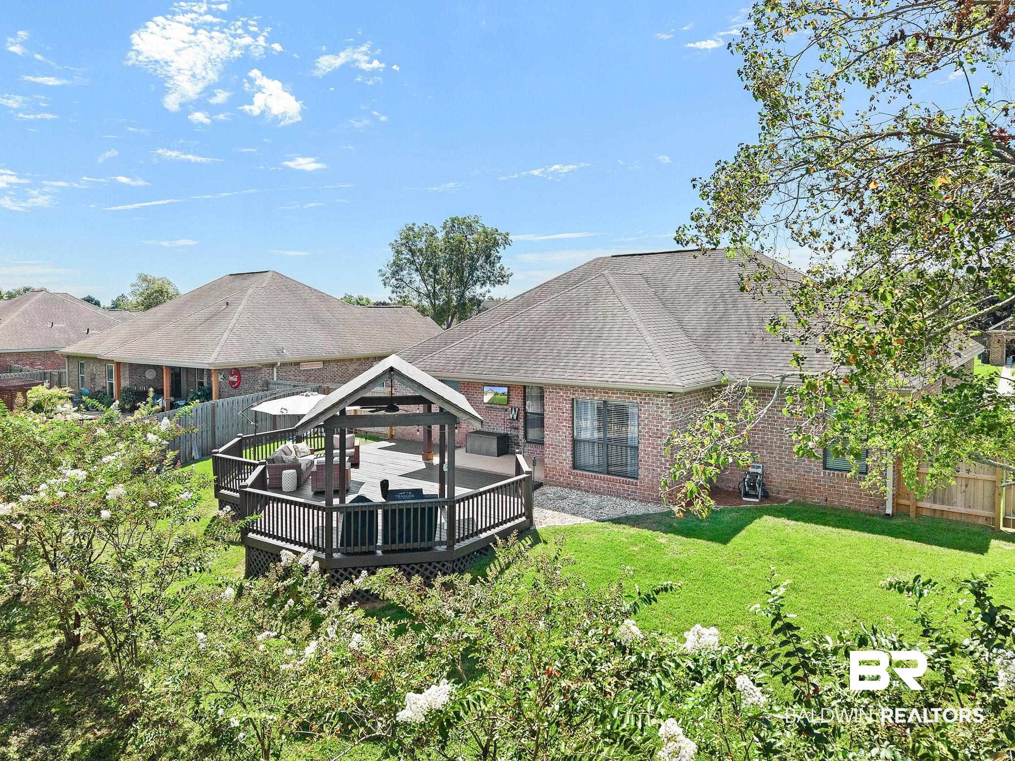 9522 Sanibel Loop Daphne, AL 36526 - Photo 38 of 43 Rear view of property with a gazebo, a fenced backyard, a deck, brick siding, and a shingled roof