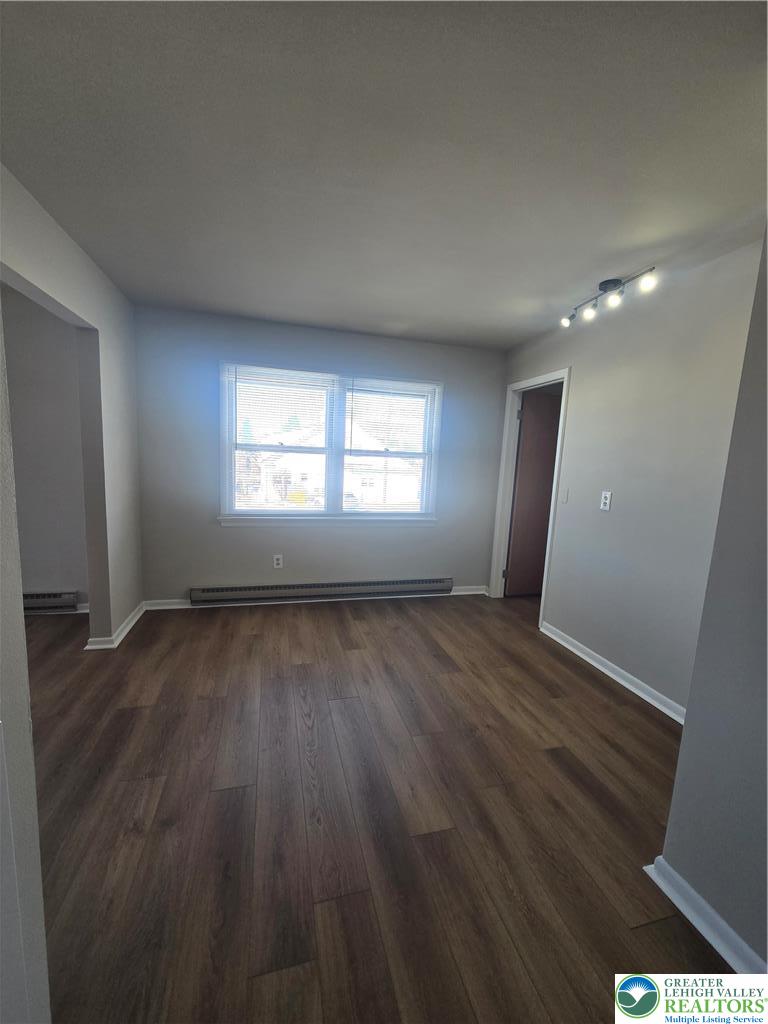 188 Jefferson Street, Unit 3 Emmaus, PA 18049 - Photo 5 of 10 an empty room with wooden floor and window