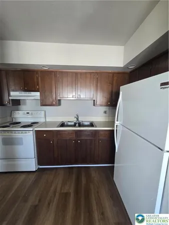 a kitchen with a refrigerator and a sink