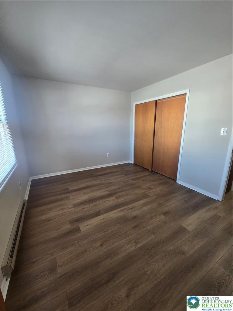 188 Jefferson Street, Unit 3 Emmaus, PA 18049 - Photo 8 of 10 an empty room with wooden floor and windows