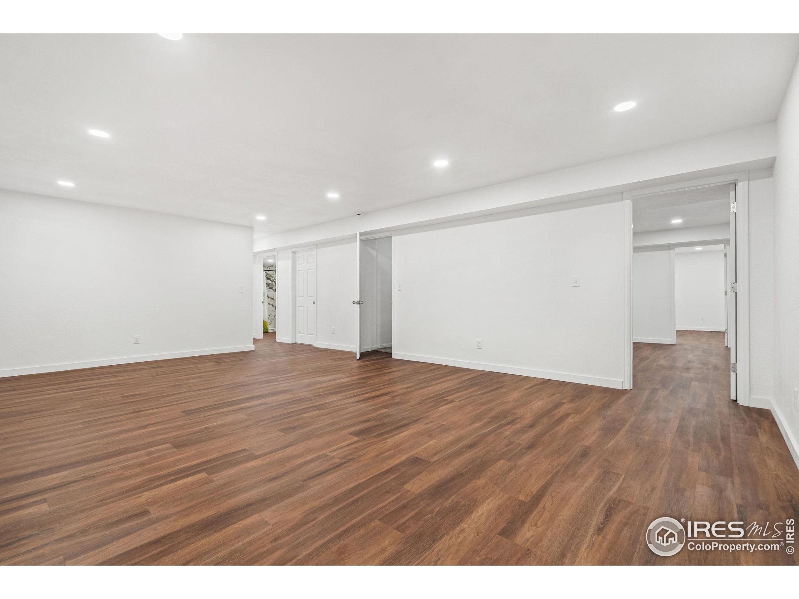 2239 Muir Lane Fort Collins, CO 80524 - Photo 18 of 31 a view of an empty room with wooden floor