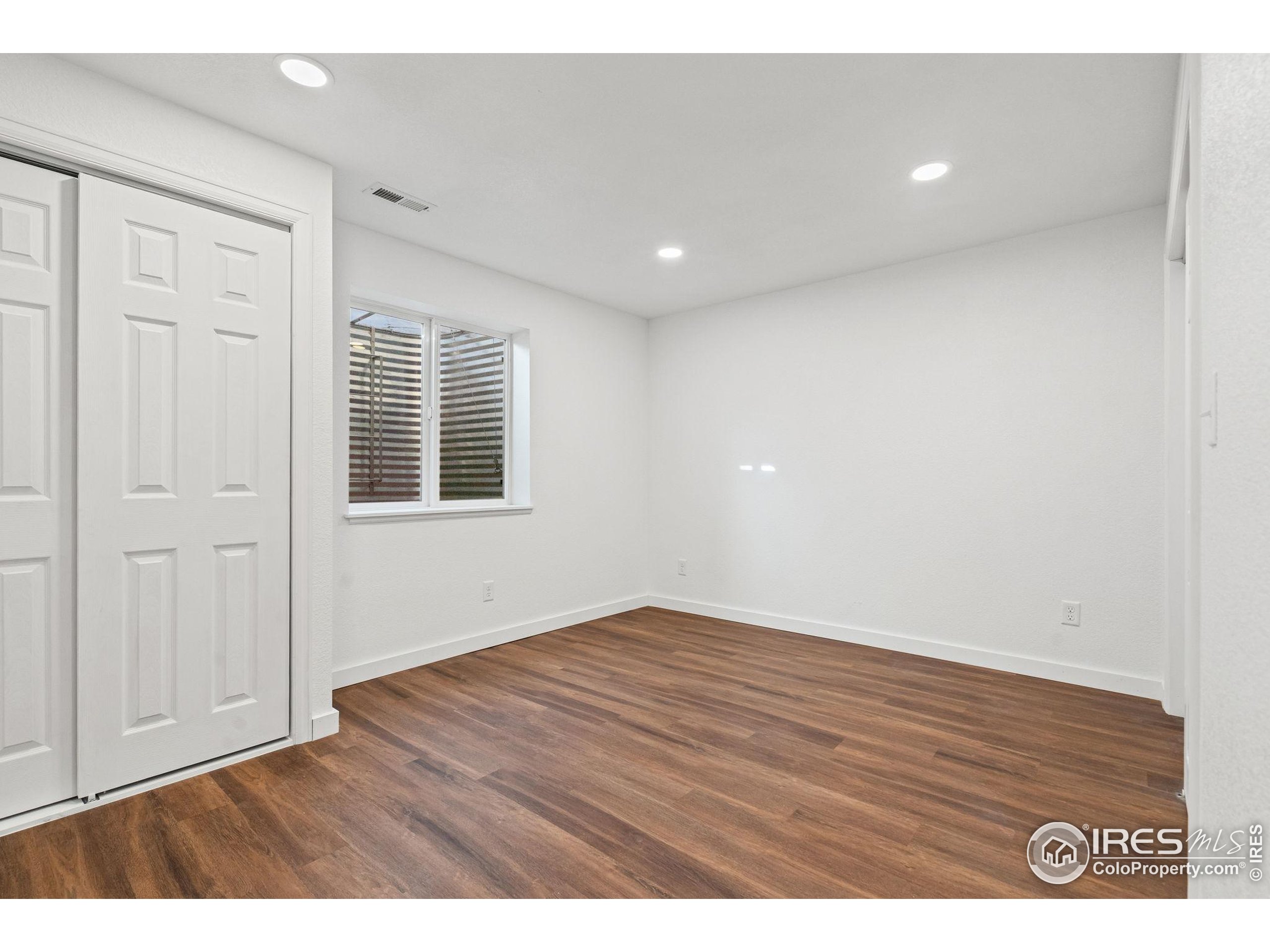 2239 Muir Lane Fort Collins, CO 80524 - Photo 23 of 31 a view of an empty room with wooden floor and a window