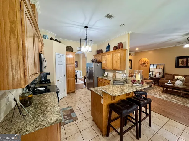 a large kitchen with a table and chairs in it