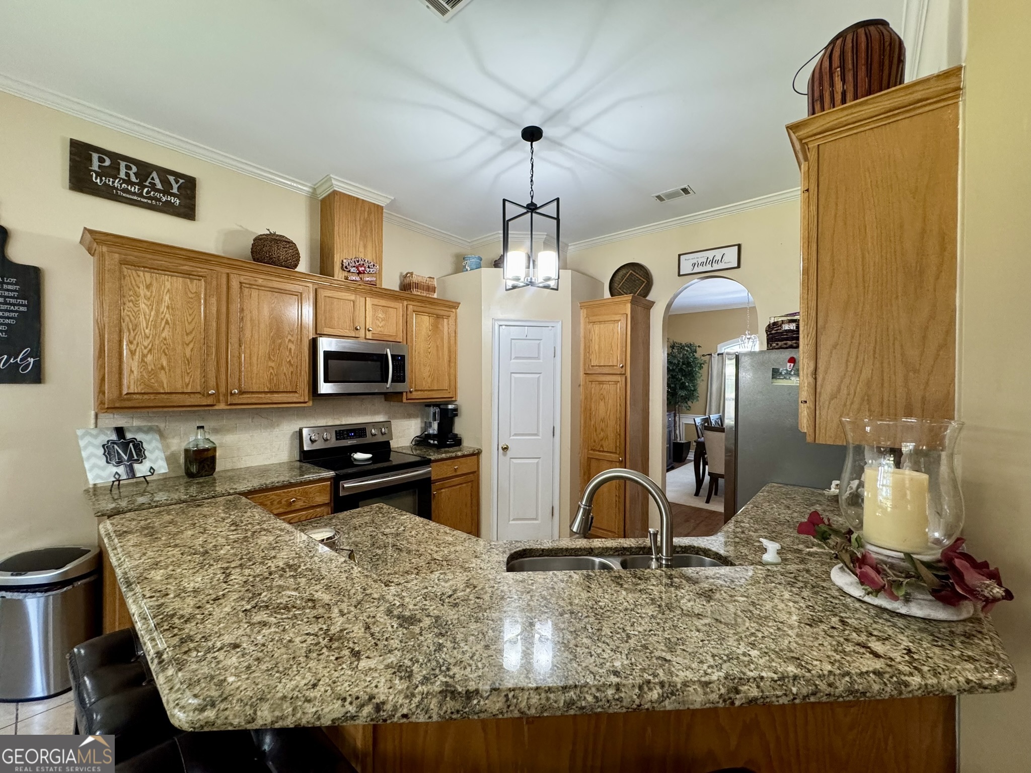 4633 Rustic Ridge Road Valdosta, GA 31602 - Photo 14 of 46 a kitchen with sink refrigerator and stove