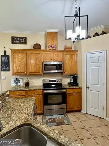 a kitchen with stainless steel appliances granite countertop a sink and a stove