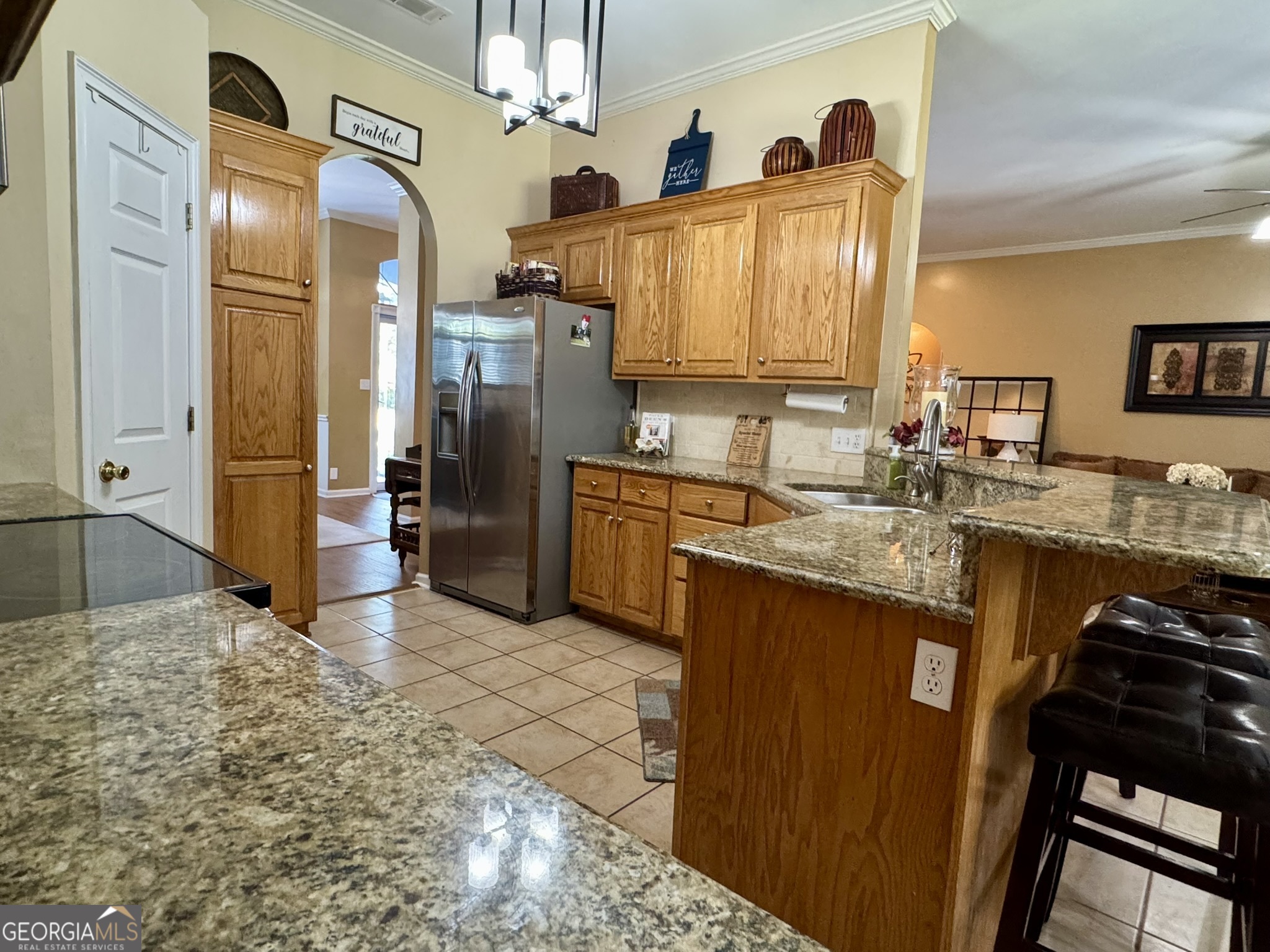 4633 Rustic Ridge Road Valdosta, GA 31602 - Photo 16 of 46 a kitchen with stainless steel appliances granite countertop a sink stove and refrigerator