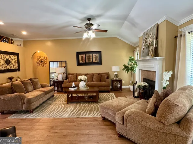 a living room with furniture fireplace and a chandelier