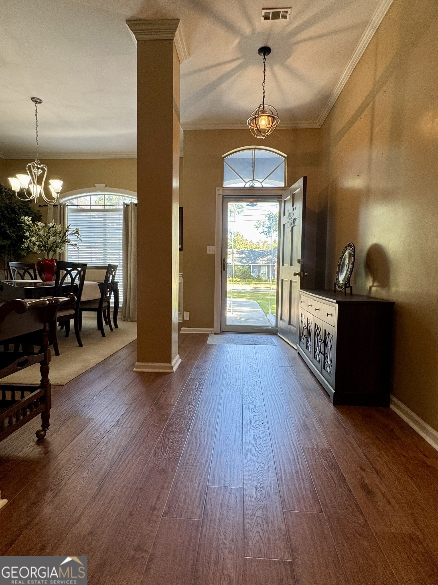 4633 Rustic Ridge Road Valdosta, GA 31602 - Photo 19 of 46 an empty room with wooden floor fireplace and windows