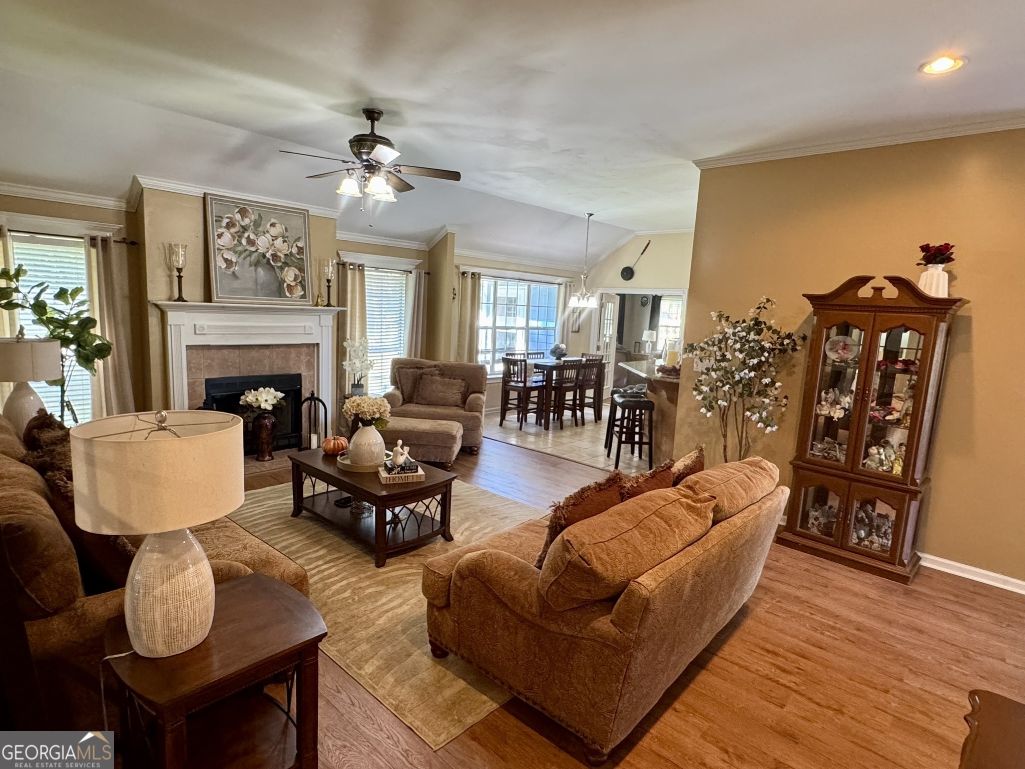 4633 Rustic Ridge Road Valdosta, GA 31602 - Photo 20 of 46 a living room with furniture kitchen view and a fireplace
