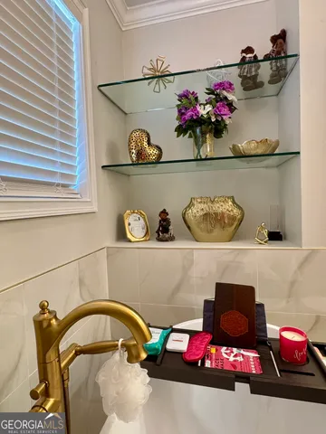 a bathroom with a sink and shelf