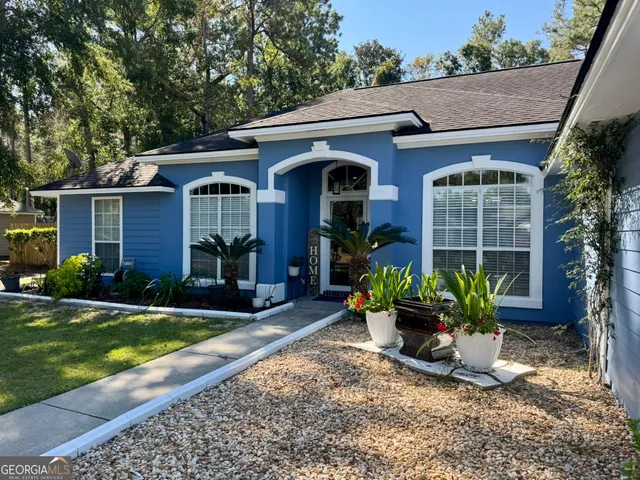 a front view of a house with garden