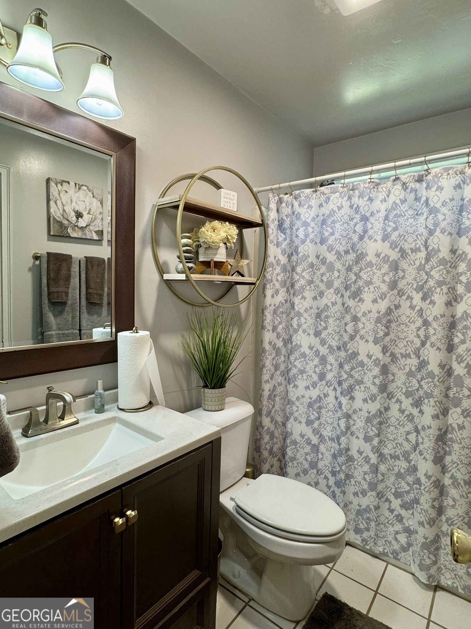 4633 Rustic Ridge Road Valdosta, GA 31602 - Photo 31 of 46 a bathroom with a granite countertop sink toilet and a mirror