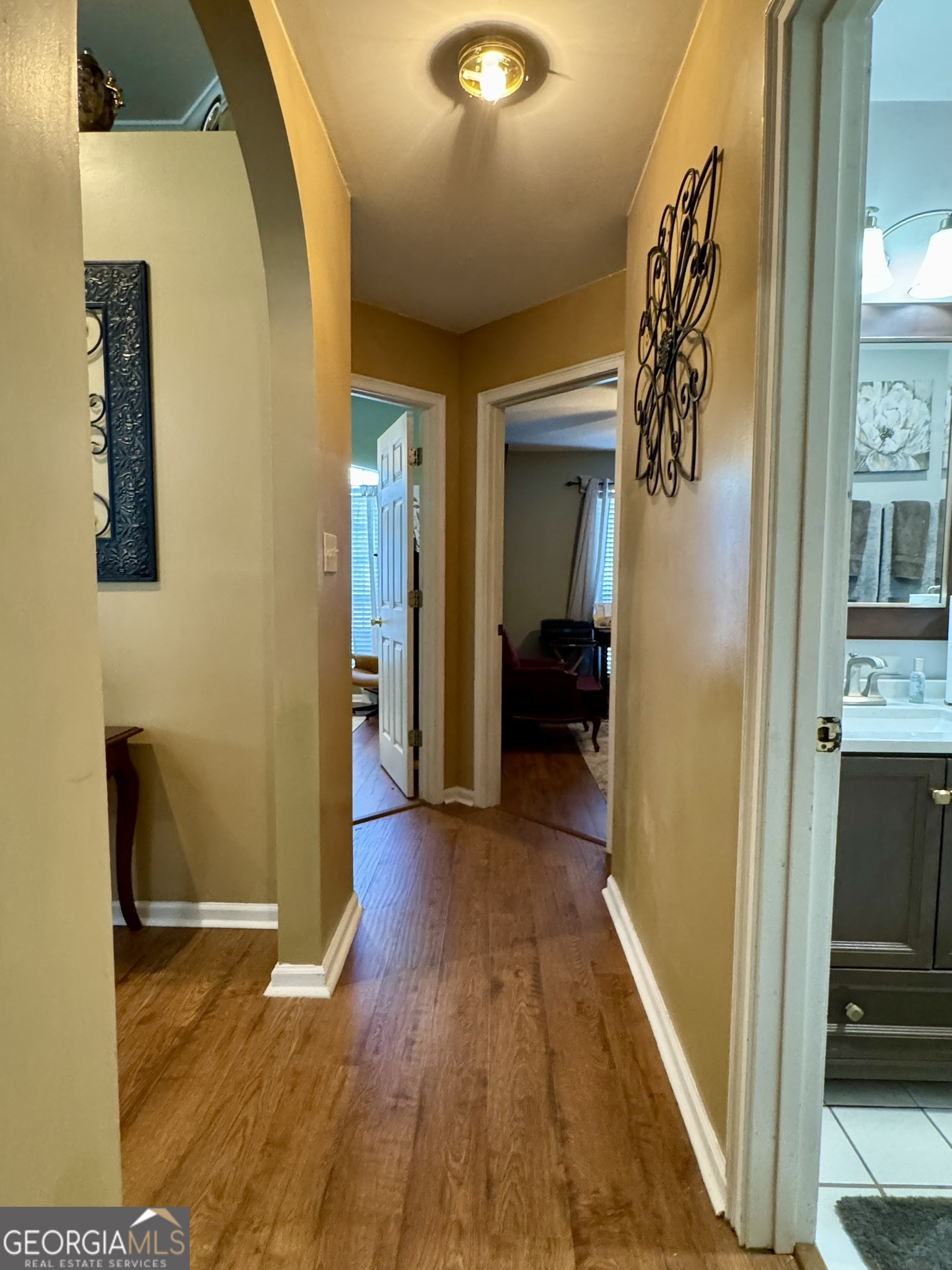 4633 Rustic Ridge Road Valdosta, GA 31602 - Photo 32 of 46 a view of a hallway with wooden floor and livingroom with furniture