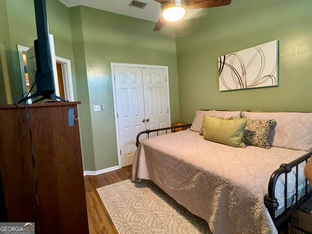 a bedroom with a bed and a mirror