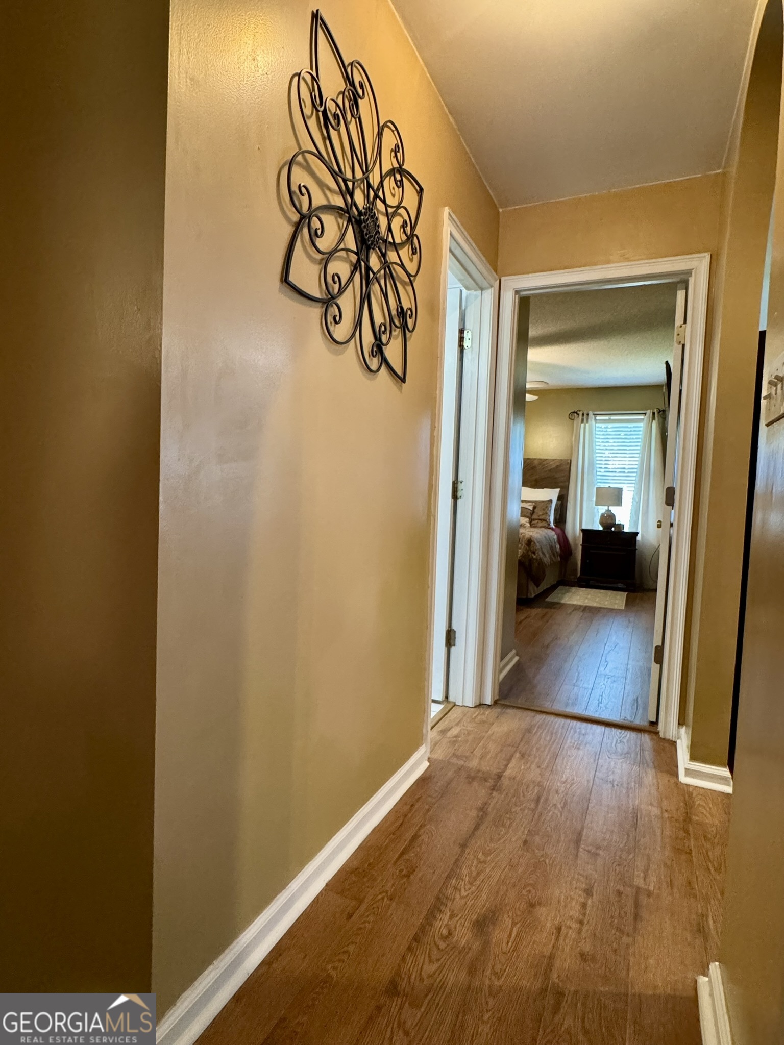 4633 Rustic Ridge Road Valdosta, GA 31602 - Photo 35 of 46 a view of a hallway with wooden floor and a bathroom