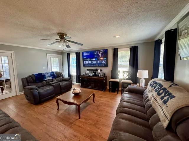 a living room with furniture and a flat screen tv