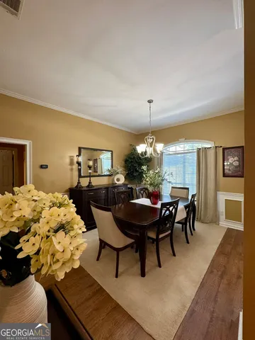 a view of a dining room with furniture and chandelier