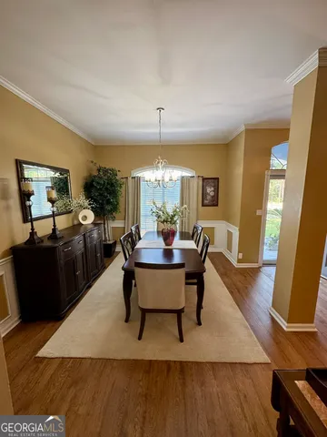 a living room with furniture a window and wooden floor