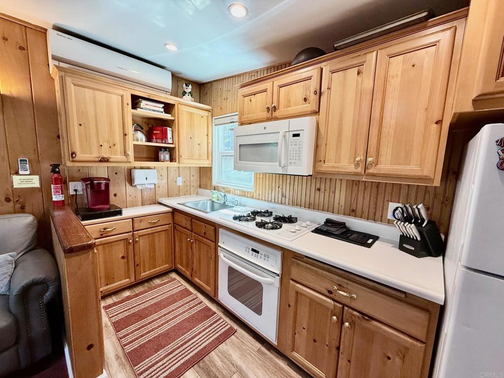 22292 Crestline Road Palomar Mountain, CA 92060 - Photo 9 of 38 a kitchen with a stove a sink and a refrigerator