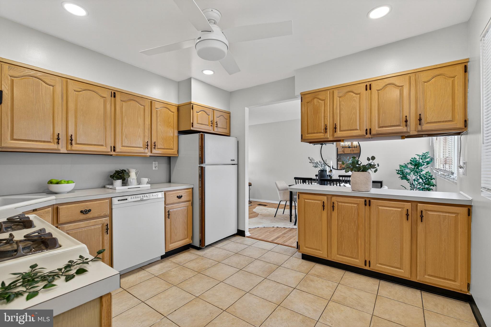 9223 Sandra Park Road Perry Hall, MD 21128 - Photo 7 of 27 a kitchen with stainless steel appliances granite countertop a refrigerator a sink dishwasher and white cabinets with wooden floor