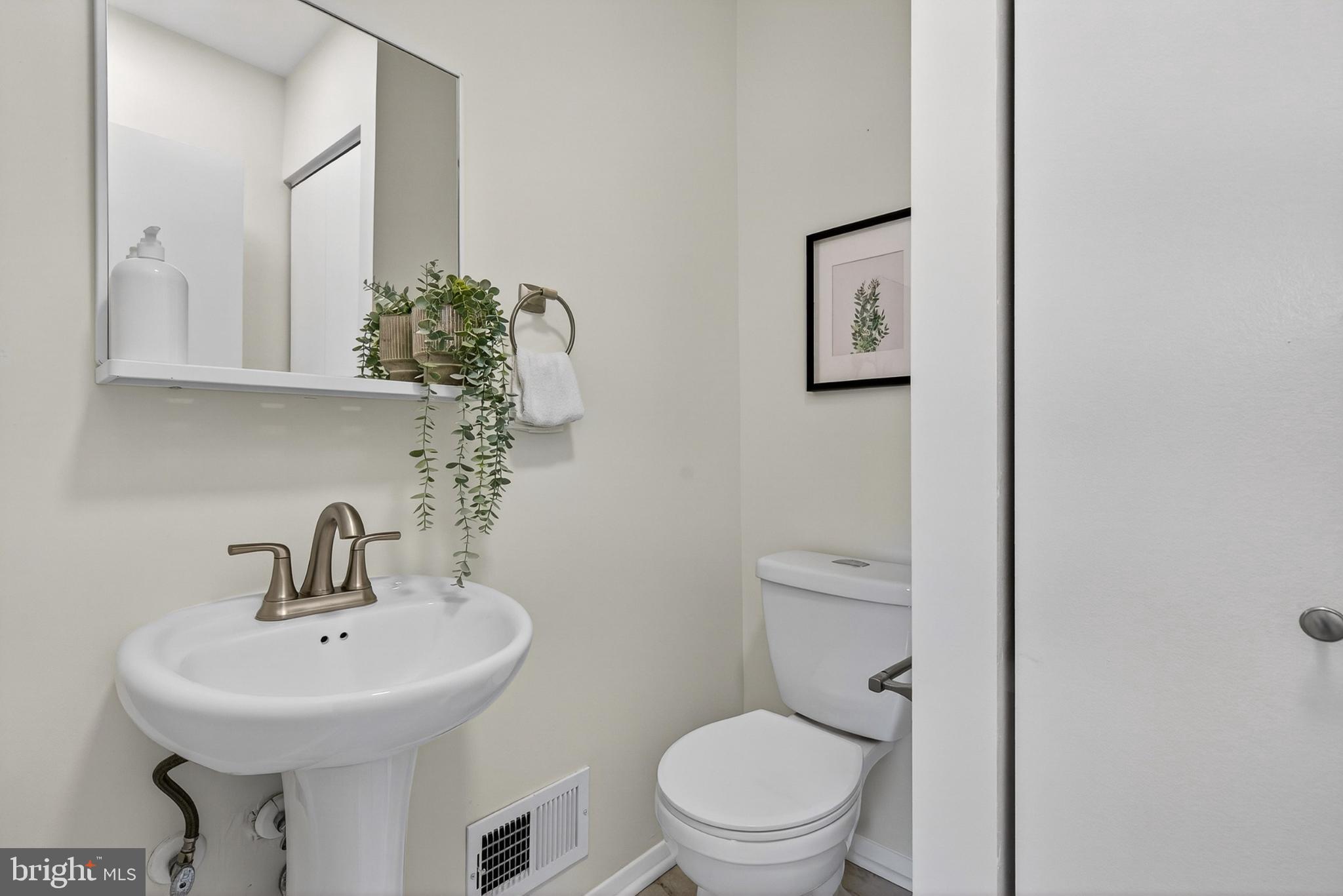 9223 Sandra Park Road Perry Hall, MD 21128 - Photo 10 of 27 a bathroom with a toilet a sink and mirror