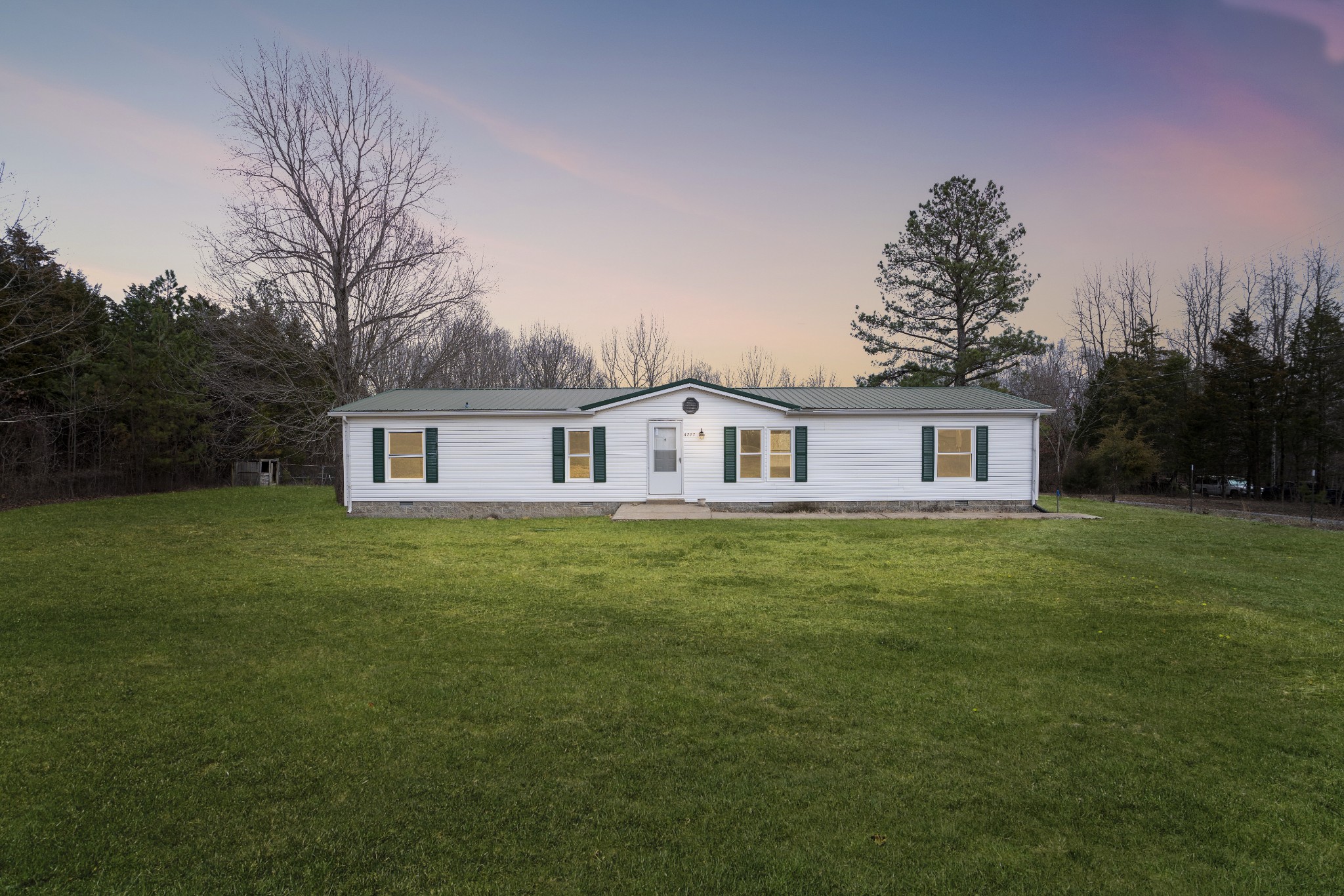 4227 Old Metal Road Palmyra, TN 37142 - Photo 2 of 16 a front view of a house with a garden