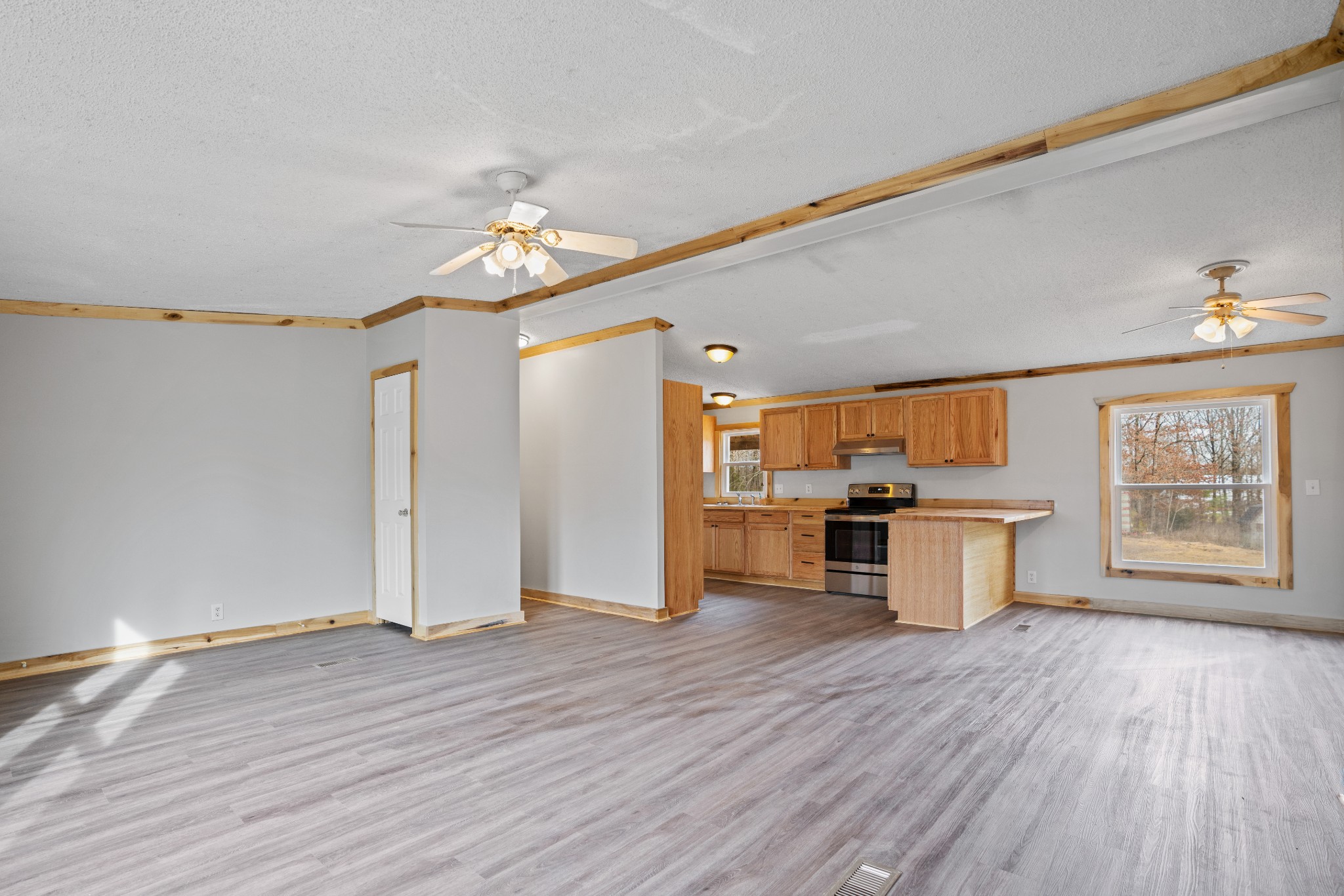 4227 Old Metal Road Palmyra, TN 37142 - Photo 3 of 16 a view of a kitchen with wooden floor and a window