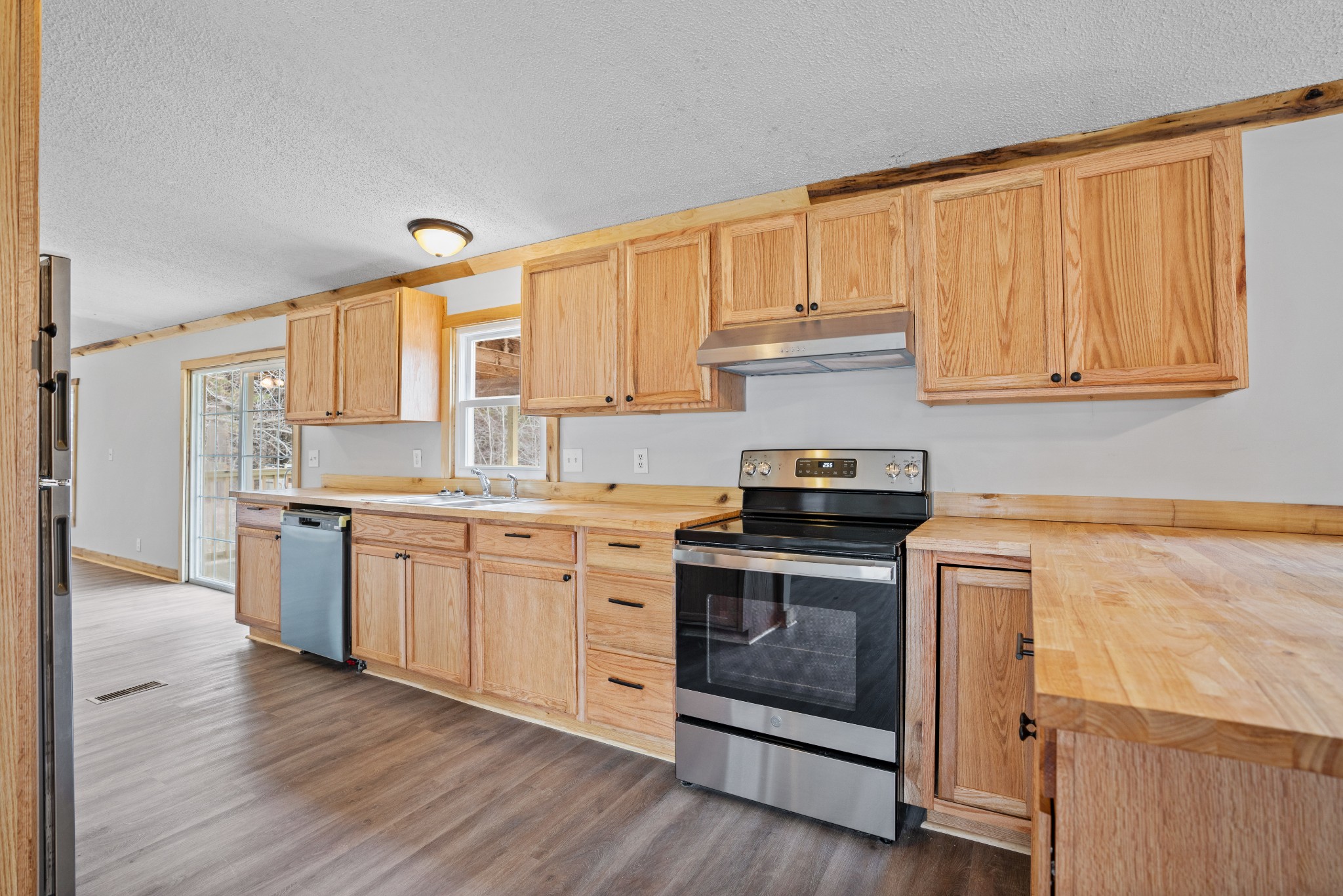4227 Old Metal Road Palmyra, TN 37142 - Photo 5 of 16 a kitchen with granite countertop wooden floors appliances and sink