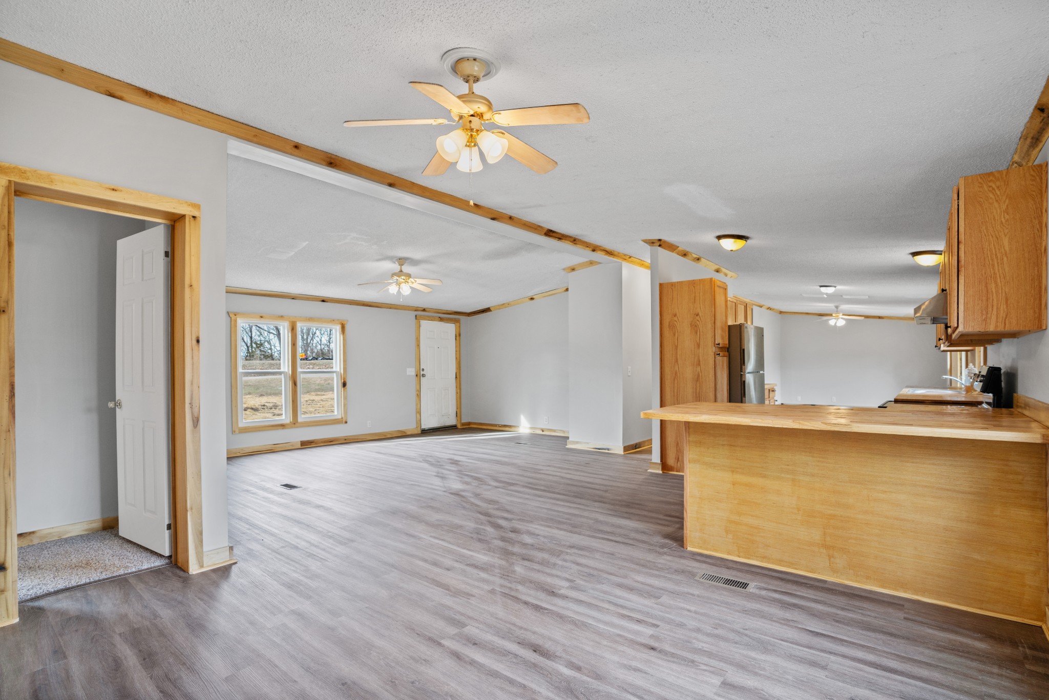 4227 Old Metal Road Palmyra, TN 37142 - Photo 7 of 16 a view of a kitchen with wooden floor and a ceiling fan
