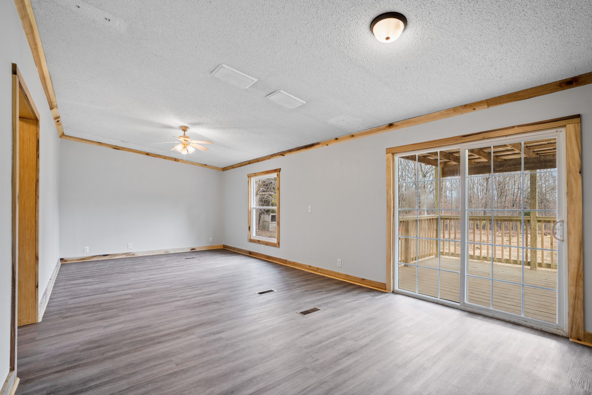 4227 Old Metal Road Palmyra, TN 37142 - Photo 8 of 16 an empty room with wooden floor and windows