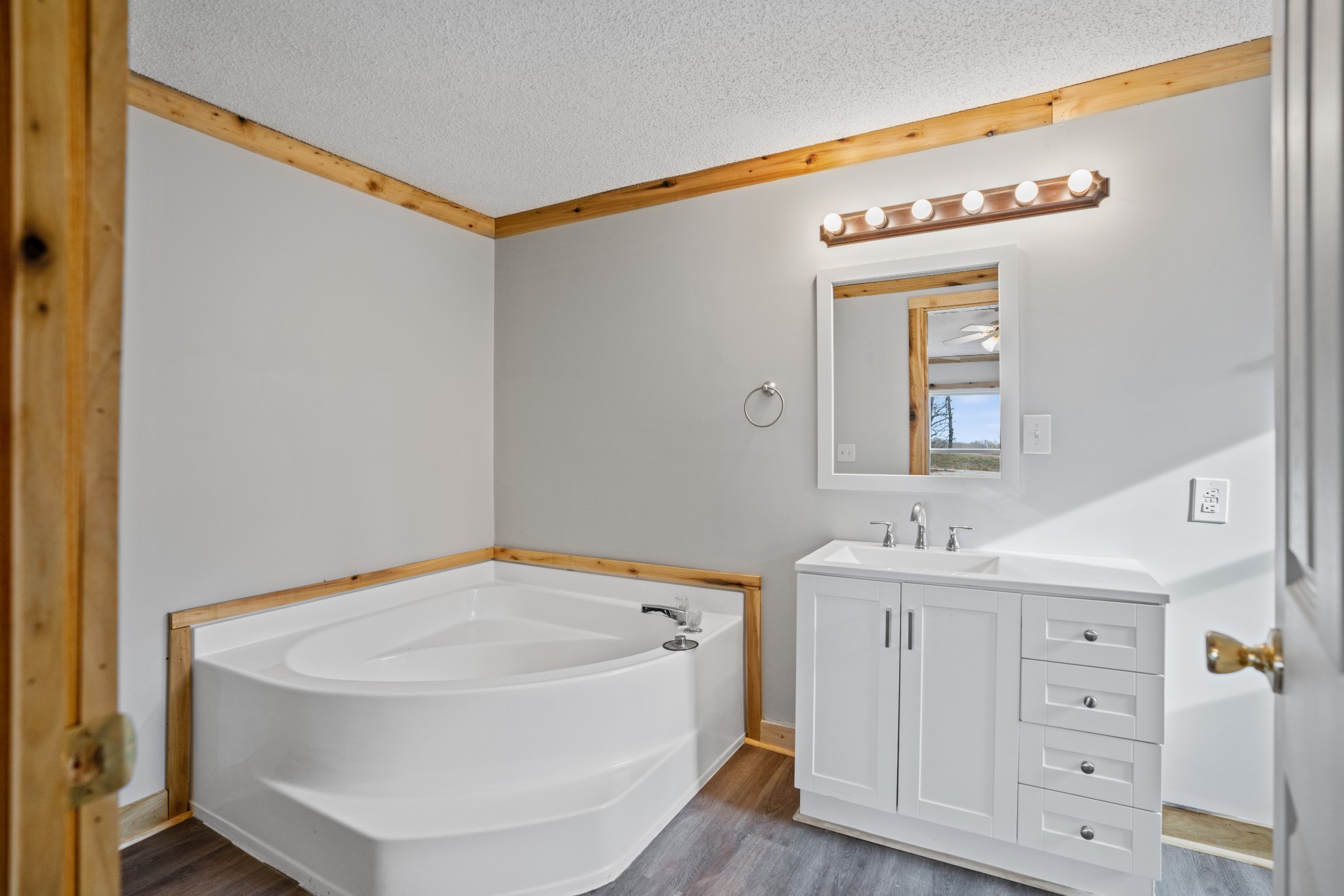 4227 Old Metal Road Palmyra, TN 37142 - Photo 10 of 16 a bathroom with a sink a mirror and a bathtub
