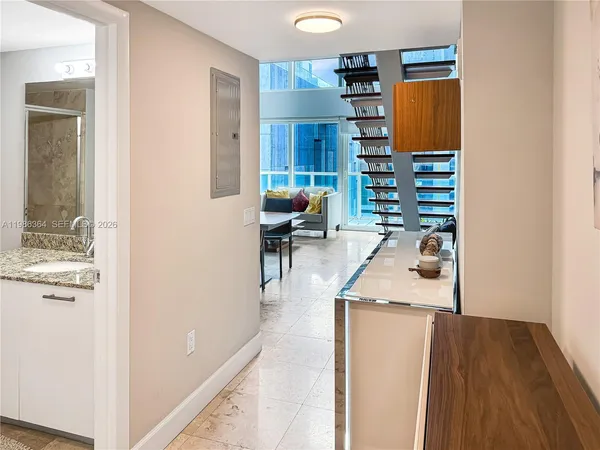 a kitchen with stainless steel appliances granite countertop a refrigerator and a wooden cabinets