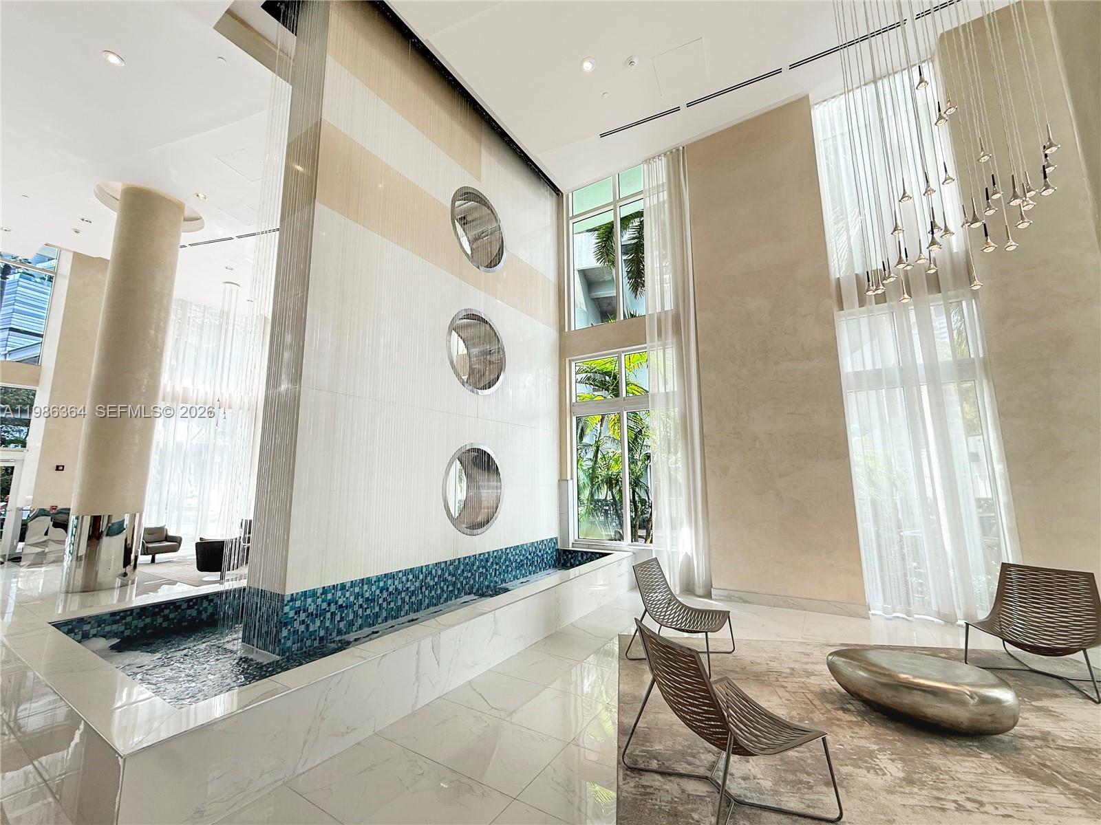 41 Southeast 5th Street, Unit 602 Miami, FL 33131 - Photo 28 of 43 a living room with a table and chair