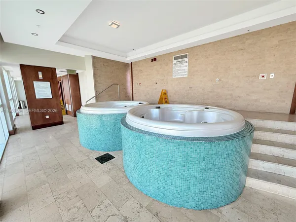 a room with a sink and mirror